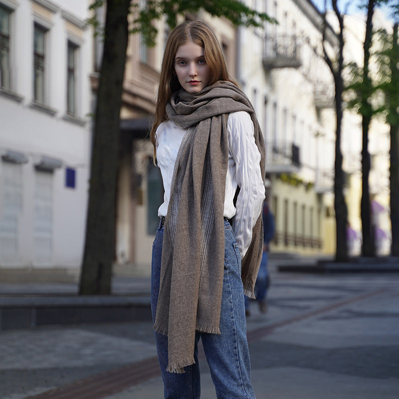 The shawl features a classic herringbone pattern, enhanced by a vertical fringe design that exudes timeless sophistication. The natural fringe, meticulously hand-finished without locking edges, ensures durability and a refined look that won’t unravel.
