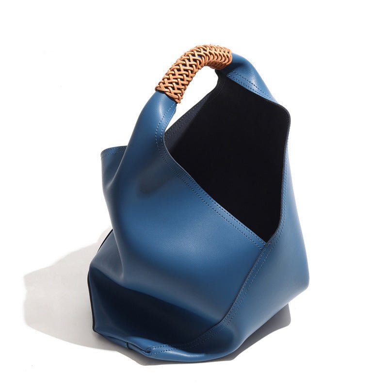 The Essential Enclave|Bucket Bag Masterpiece|Small Grain Cowide Leather-Our artisans have woven a pure cowhide handle that is both durable and visually striking, ensuring comfort and style whether carried on the shoulder or in hand. It gradually softens with use, enveloping you in a vacation-like ambiance with each carry. 